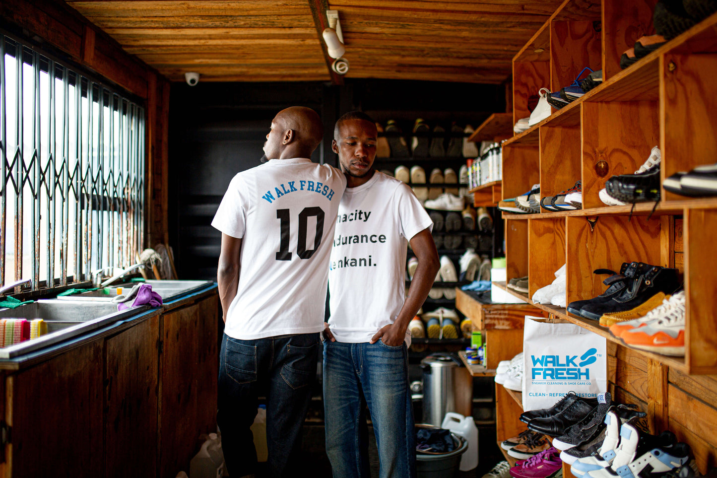 Walk Fresh 10-Year Celebration T-Shirt worn by models, showcasing sneaker culture in a stylish setting.